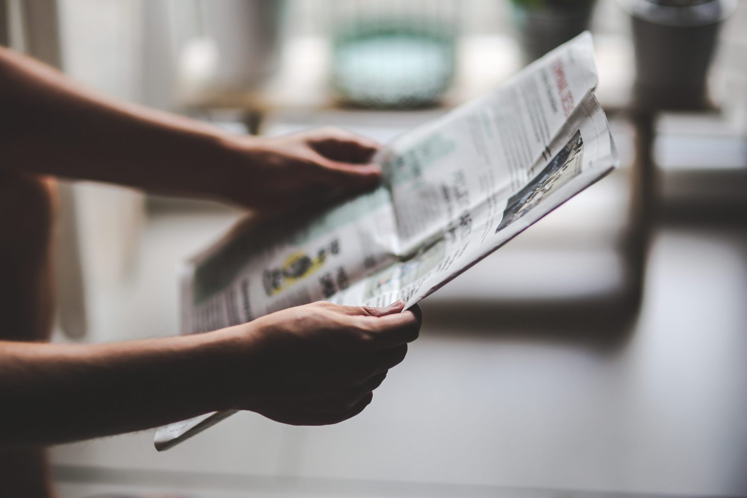 Image of a person reading print zine content