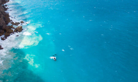 a blue sea and rocky shoreline